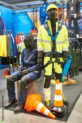 Protective workwear mannequins with safety gear at trade show