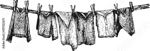 vintage hand drawn laundry hanging on clothesline with wooden clothespins and various garments