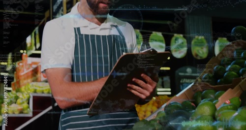 Camera widening produce clerk checking avocados writing stock on pad with pen overlays crossing pad
