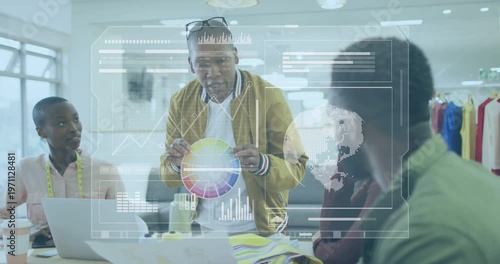 Lead designer rotating color wheel, raising it toward team, generating overlay charts for fashion