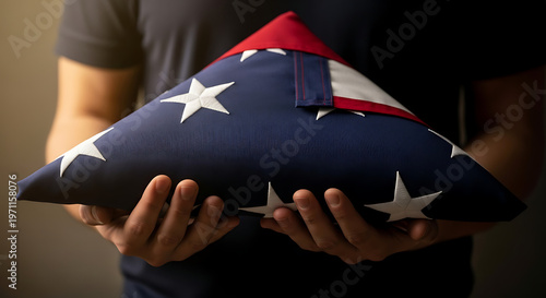 anonymous hands hold folded american flag