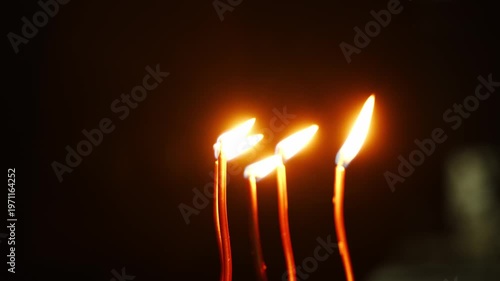 Lighting candles for celebration during evening gathering in local area