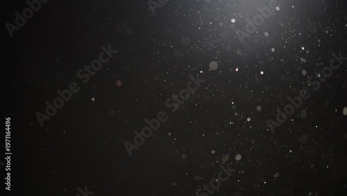 Fotografie Real dust particles floating in air over dark background