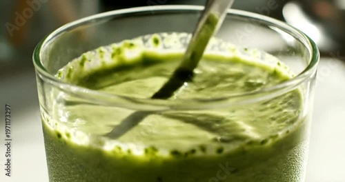 Healthy green smoothie with spoon.