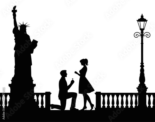 Man proposing to woman near statue of liberty silhouette