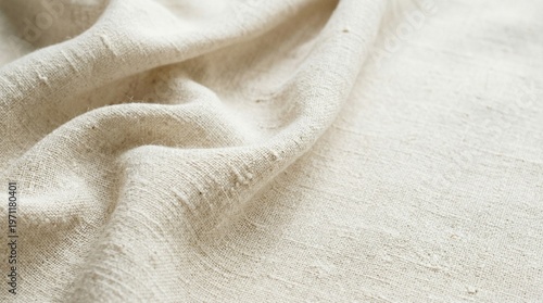 Natural Ecru Linen Fabric Texture with Soft Drapery Folds. A professional close-up shot of raw, unbleached ecru linen cloth. The image highlights the organic weave and natural fiber texture 