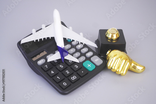 Broken golden thumbs up and airplane model with calculator on grey background. Bad airways company service and expensive tickets concept.