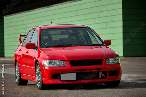 Εκτύπωση καμβά Red car on the street, sports sedan parked on an empty road with guardrails in d