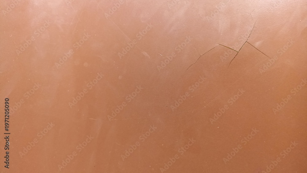 Fototapeta premium Subtle Cracked Brown Surface Texture Background. Minimal brown surface with fine cracks and soft wear, clean abstract texture for background use