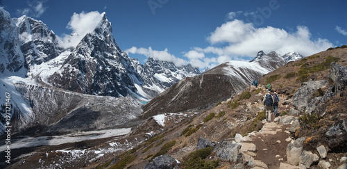 Panoramic View of the Snowy Himalayan Range with Adventurous Trekkers on the mountain Trail to Mount Everest Base Camp. Nepal
