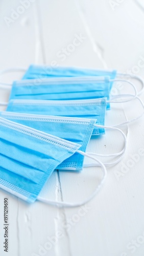 Close-up of Three Blue Medical Masks on White Wood
