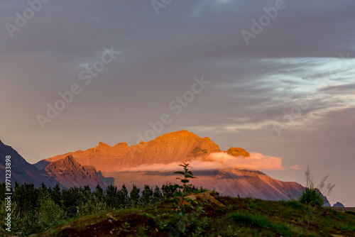 Rugged mountains rises against the horizon across Northern Iceland under heavy, brooding skies