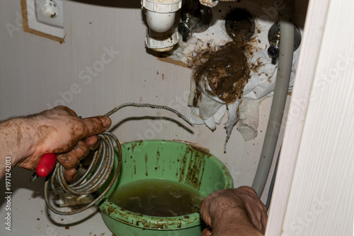 Quadro su tela Handyman's dirty hands, plumber fixing a clogged pipe, authentic small business work