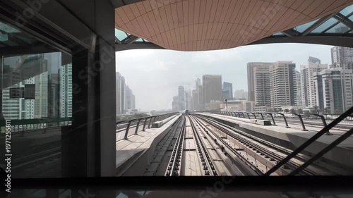 Futuristic Driverless Metro Train Moving on Elevated Tracks through Dubai Skyscrapers