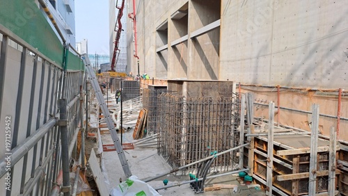 Large Scale Construction Site with Concrete Pump and Rebar Structure