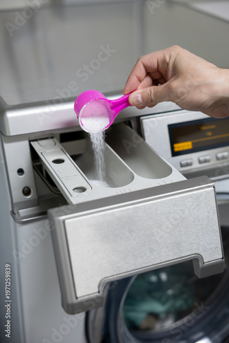 man putting a washing machine to washing machine