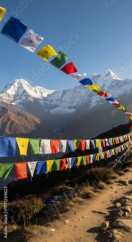 Colorful prayer flags flutter against a backdrop of majestic mountains and clear blue skies.