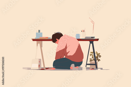 Young caucasian male sitting by desk in thoughtful moment