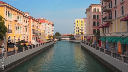 Picturesque canals of Qanat Quartier at The Pearl-Qatar, Doha. Venetian-inspired architecture with pastel buildings, arched bridges,