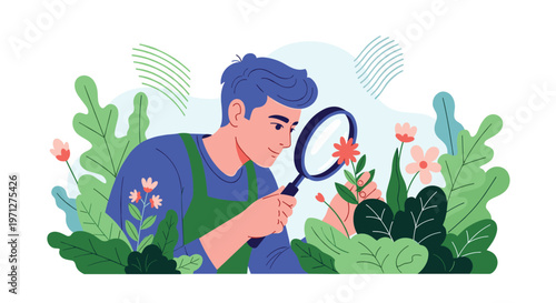 Young man in a green apron using a magnifying glass to carefully inspect a blooming red flower in a garden.
