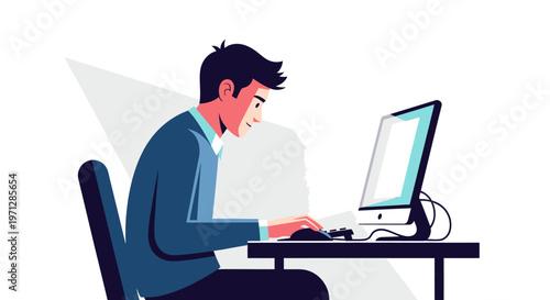 Focused young man diligently typing on a desktop computer at a simple desk in a bright studio, dedicated to his work.