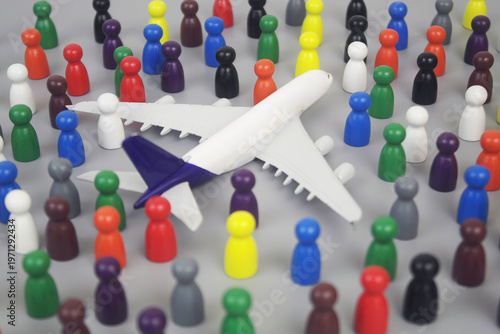 Airplane model and many people figures on grey background.