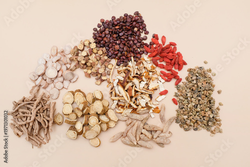 Various traditional Chinese medicinal herbs arranged in loose piles on a neutral background