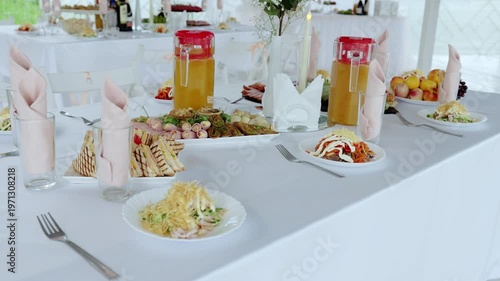 Wedding reception table featuring gourmet dishes, sparkling beverages, and luxurious place settings, highlighting elegant dining experience during celebratory event