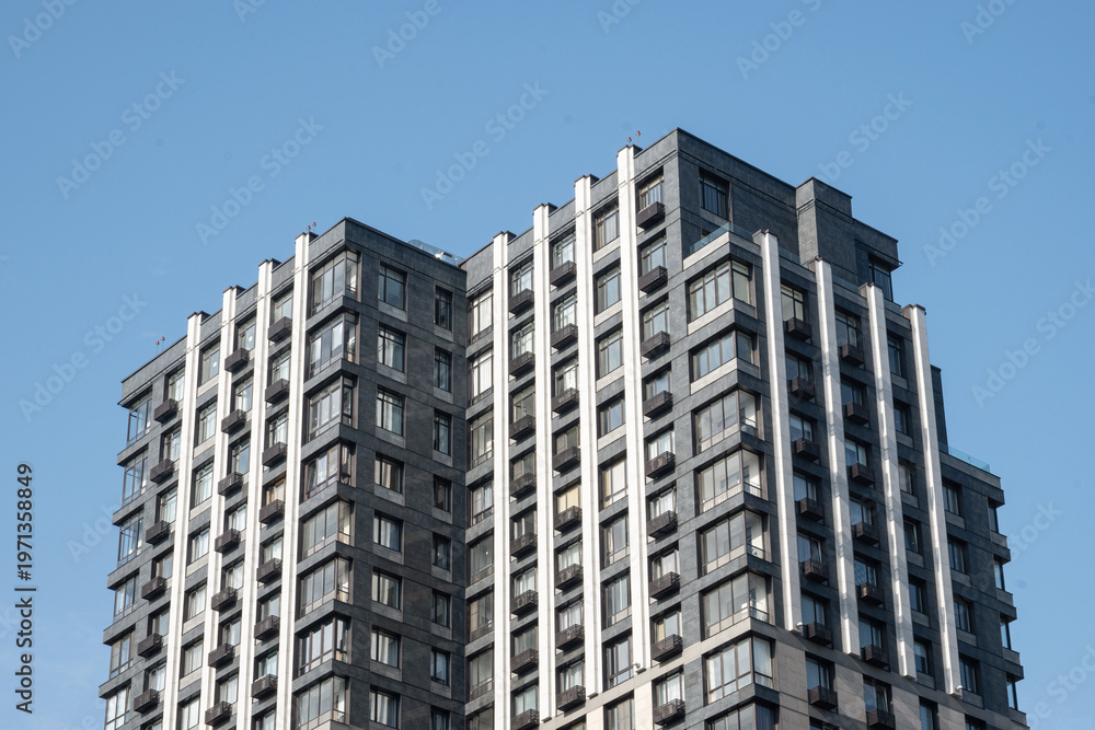 Fototapeta premium Modern apartment building corner perspective against blue sky