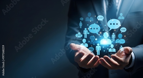 Businessman presenting a collection of glowing blue social media and people icons in his hands