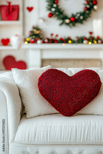 A red heart placed on a white couch, suitable for romantic or Valentine's Day themes