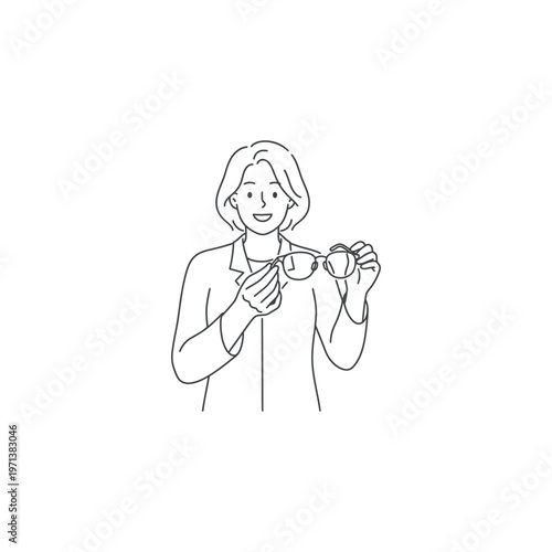 Woman holding and examining eyeglasses.