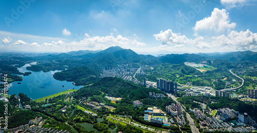 Panoramic aerial view of Shenzhen city skyline with Wutong mountain and reservoir under blue sky in China.