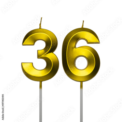 Schilderij op canvas A pair of shiny golden birthday candles in the shape of the number thirty six, featuring a spiral textured surface and isolated on a plain white background