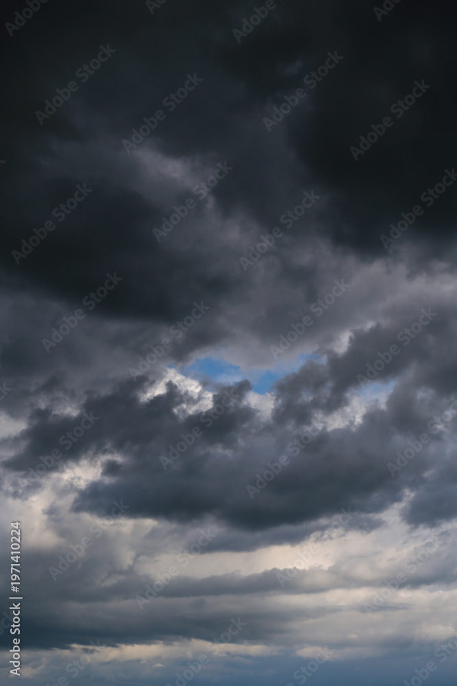 Fototapeta premium Storm cloudy sky with dark cumulus clouds and blue sky background texture, thunderstorm, heaven
