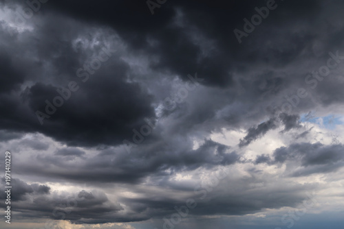 Stormy cloudy sky with dark rainy thunderstorm cumulus clouds background texture