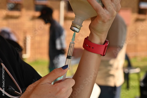 Obraz na plátně A vet fills a syringe to inoculate a dog in Johannesburg.