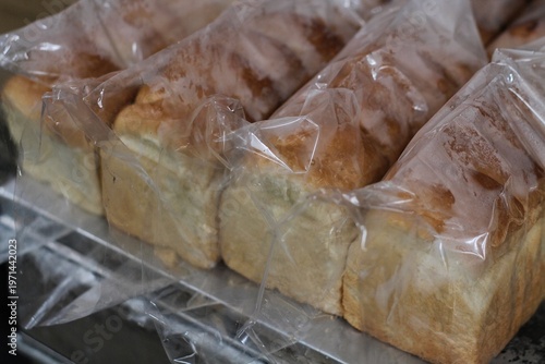 Foto Fresh Sliced Loaves Of White Bread Packaged In Plastic