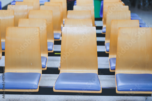 Rows of empty chairs in a waiting area.