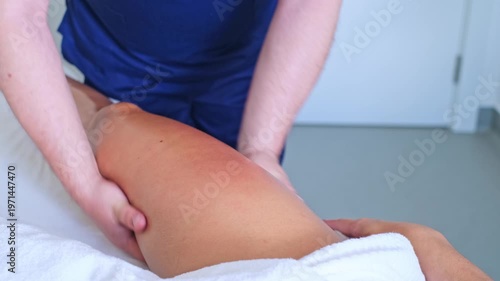 Calming leg and thigh massage focused on relaxation and lymphatic drainage using soothing oil at a spa salon.