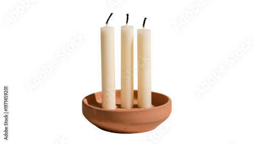 Schilderij op canvas Three unlit cream pillar candles in a terracotta dish, isolated on transparent b