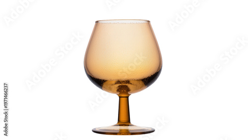 Photos Amber colored brandy snifter glass with textured surface, isolated on transparen