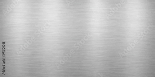 A polished silver stainless steel plate with a brushed metal texture creates a shiny metallic industrial surface pattern on this grey aluminum material background