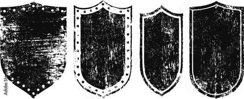 Set of four vintage distressed shields in black and white grunge texture design elements