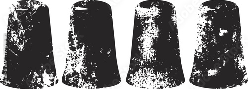 Four grunge textured black rubber stopper caps with distressed worn surfaces isolated on white