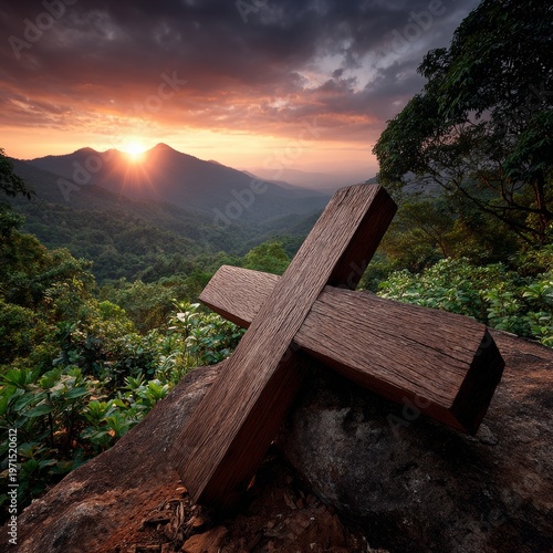Majestic sunset over mountains with a wooden cross