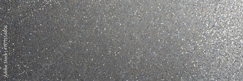 A high resolution texture of shimmering silver glitter and sequins reflecting light with a subtle gradient effect