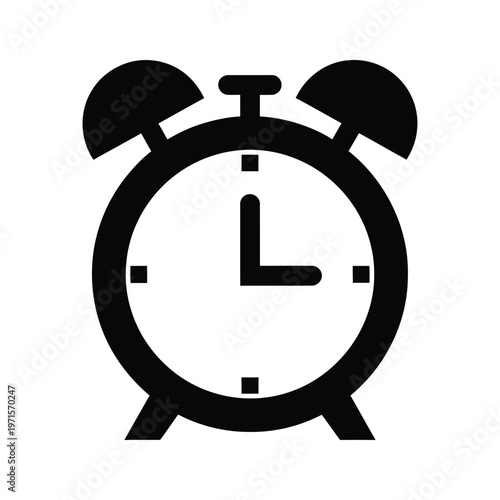 Black and white alarm clock showing time just before midnight with bells extended