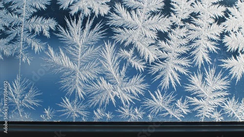 Frosty windowpane ice crystals formation.