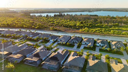 Fort Myers, Florida luxury housing neighborhood aerial drone still photo during bright sunset.